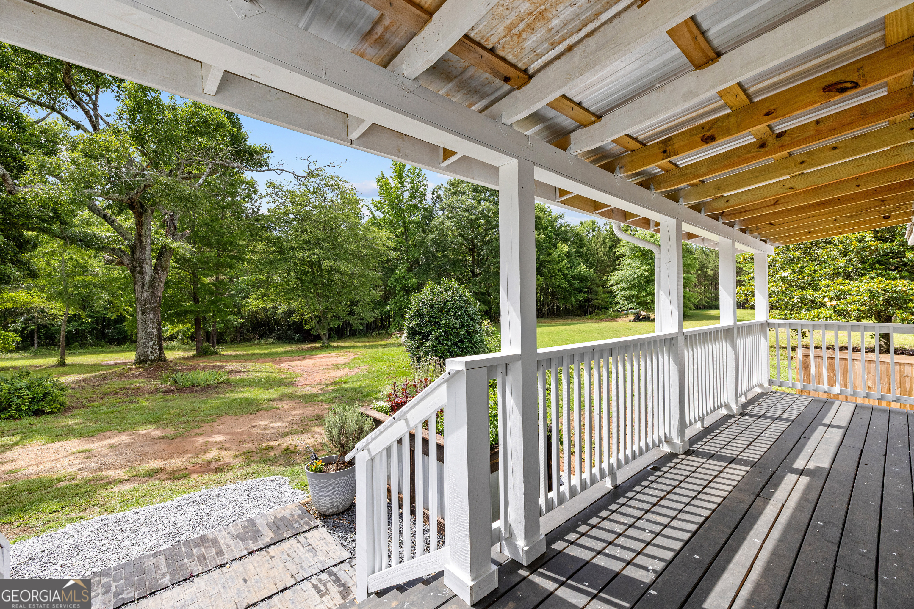 1329 Standing Rock Road Senoia, GA 30276 - Photo 4 of 77 a view of a porch with wooden floor next to a yard