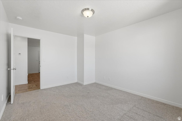 1218 Moonlight Drive Elk Ridge, UT 84651 - Photo 12 of 44 Spare room with baseboards and light carpet