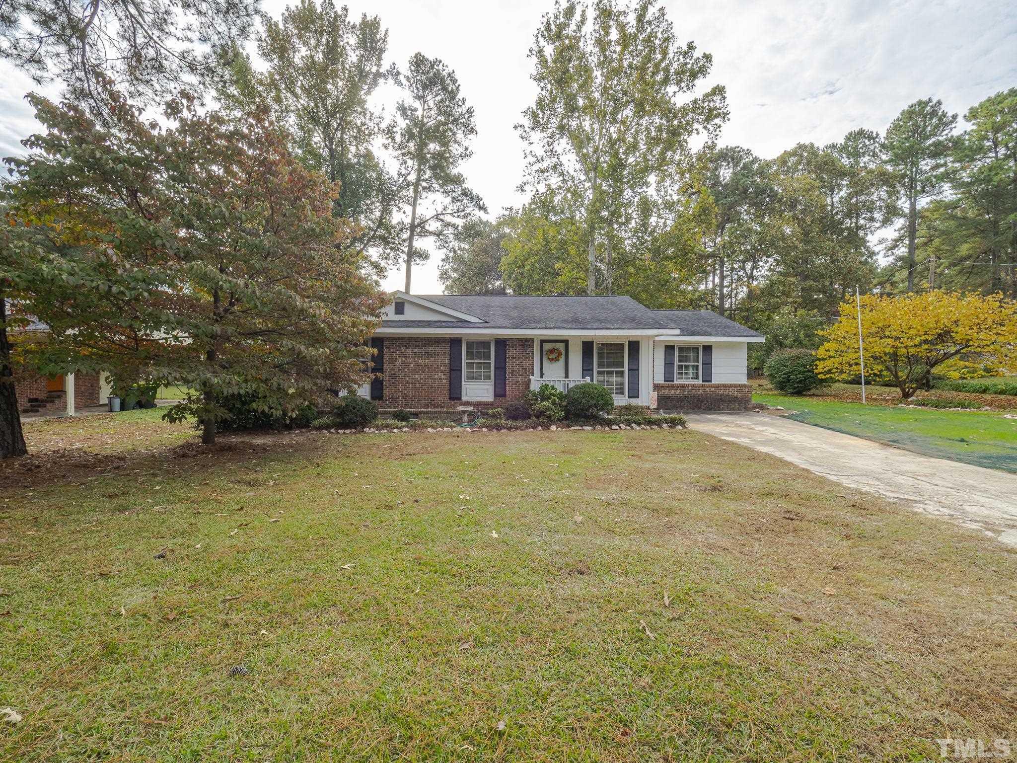 6400 Buffaloe Road Raleigh, NC 27604 - Photo 1 of 25 a front view of a house with a yard and trees