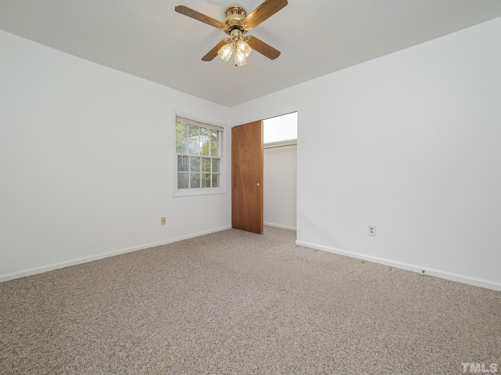 6400 Buffaloe Road Raleigh, NC 27604 - Photo 11 of 25 an empty room with windows and fan