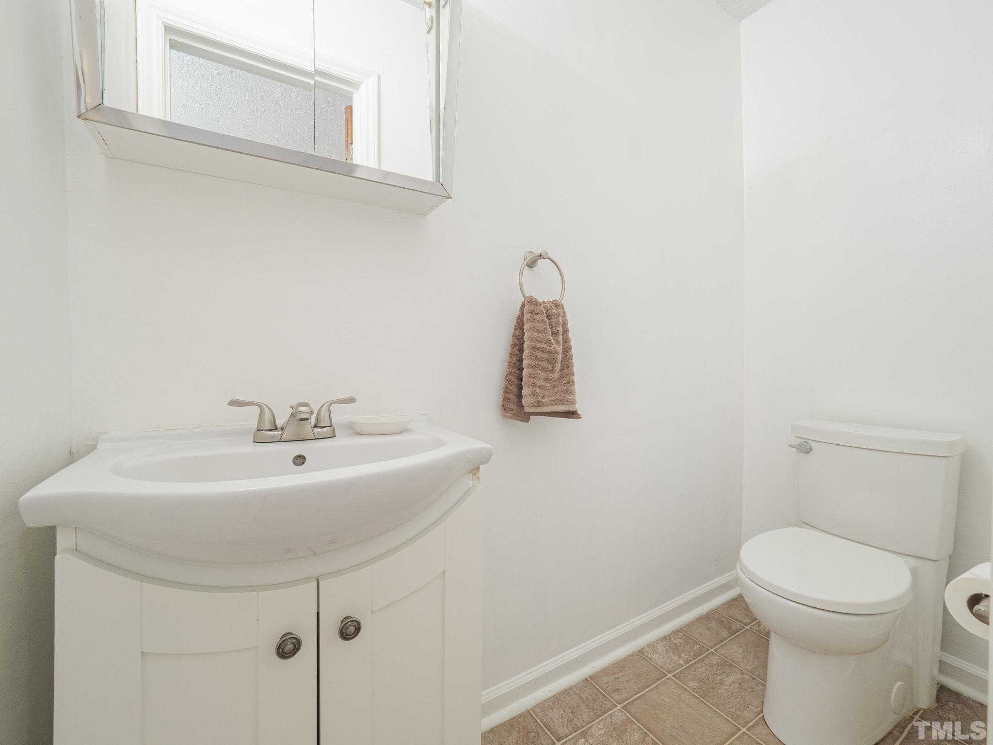6400 Buffaloe Road Raleigh, NC 27604 - Photo 12 of 25 a bathroom with a sink a toilet and mirror