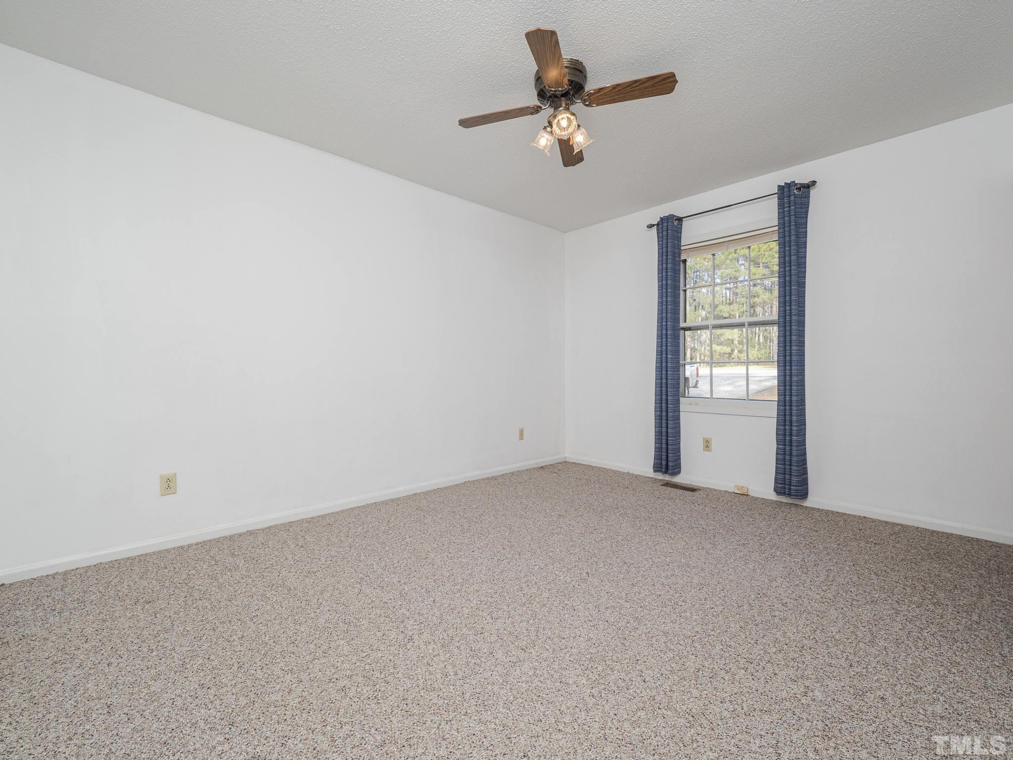6400 Buffaloe Road Raleigh, NC 27604 - Photo 15 of 25 an empty room with windows and fan