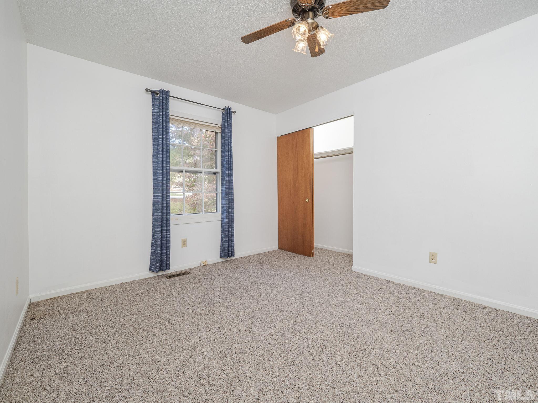 6400 Buffaloe Road Raleigh, NC 27604 - Photo 16 of 25 an empty room with chandelier fan