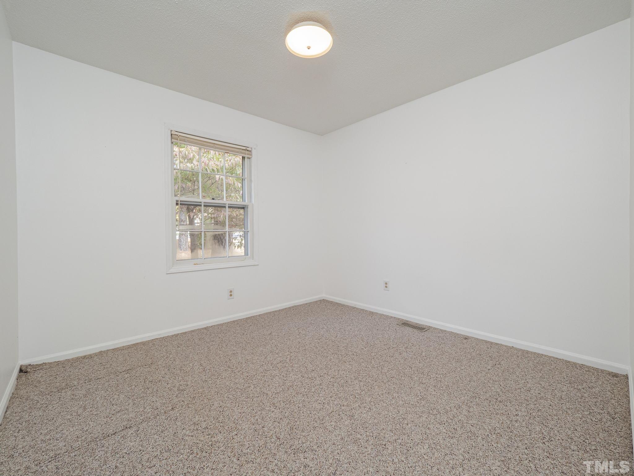 6400 Buffaloe Road Raleigh, NC 27604 - Photo 17 of 25 an empty room with a window