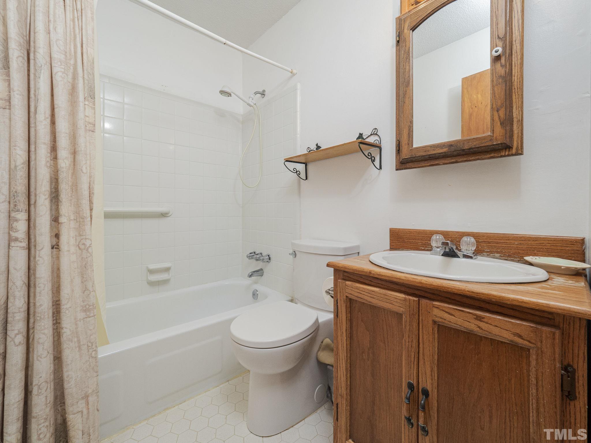 6400 Buffaloe Road Raleigh, NC 27604 - Photo 19 of 25 a bathroom with a sink a toilet and shower