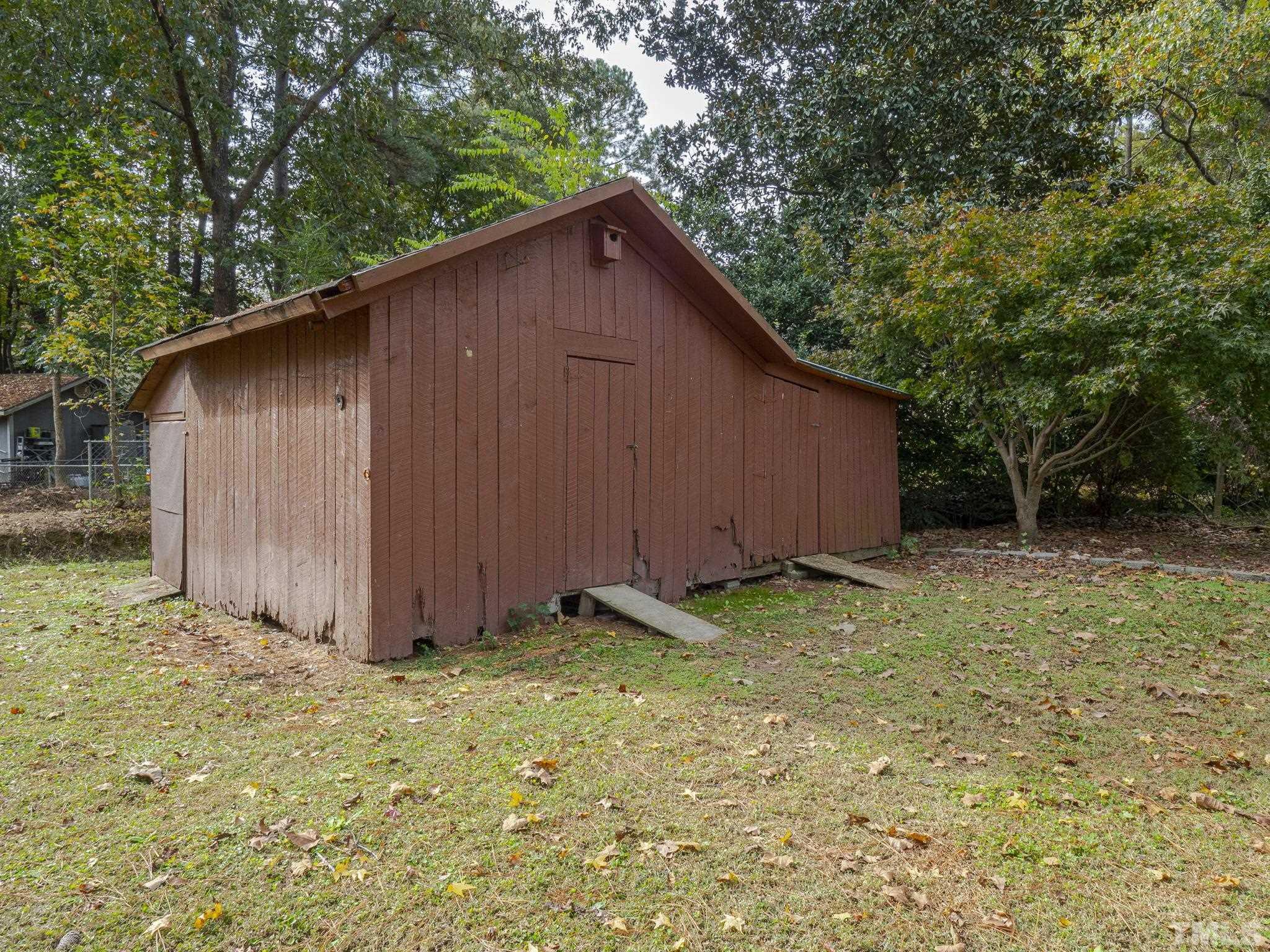 6400 Buffaloe Road Raleigh, NC 27604 - Photo 23 of 25 a backyard of a house with lots of plants and tree