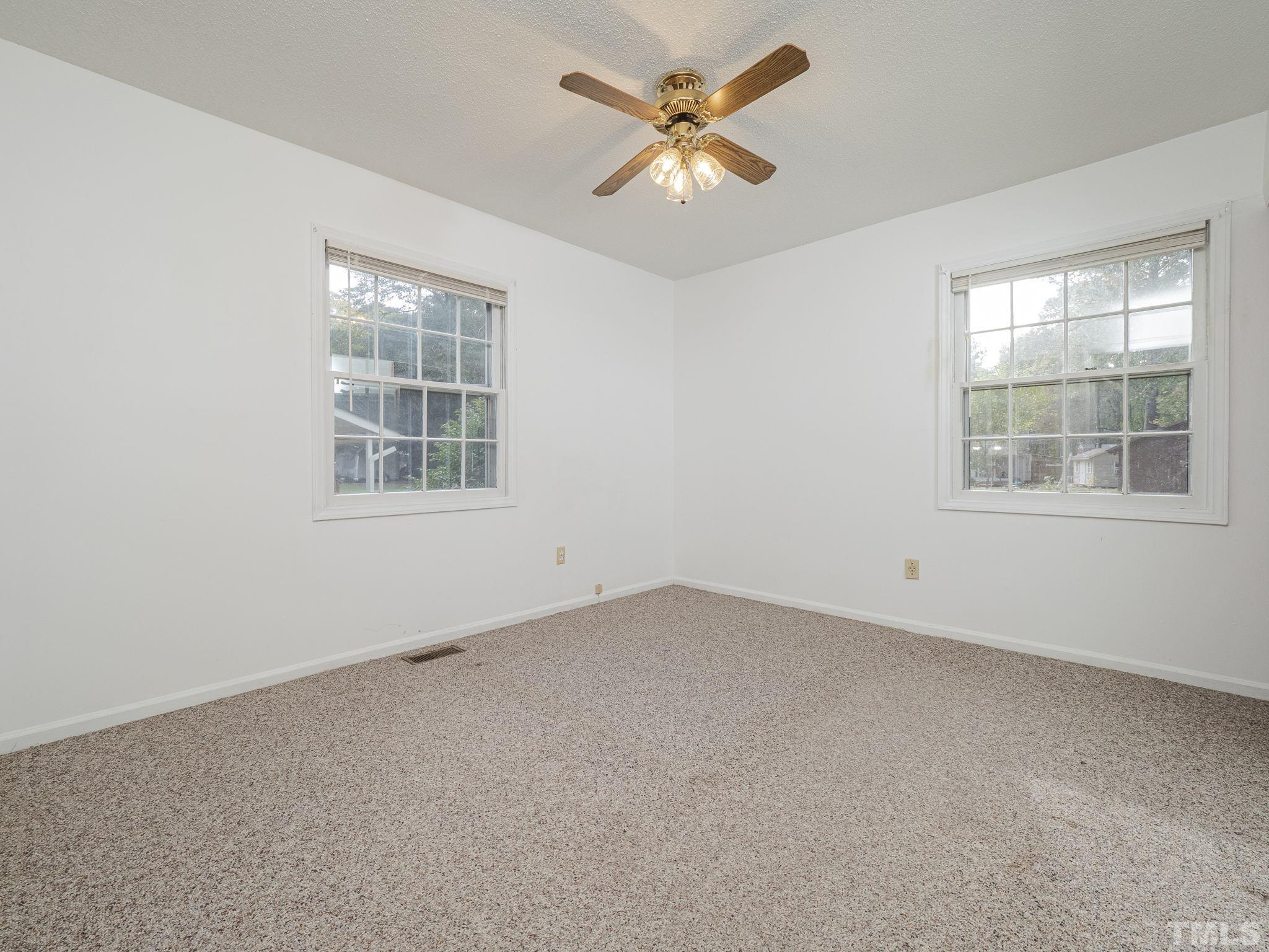 6400 Buffaloe Road Raleigh, NC 27604 - Photo 10 of 25 an empty room with a window and a fan