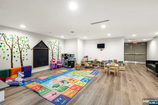 a living room filled with furniture and a wooden floor