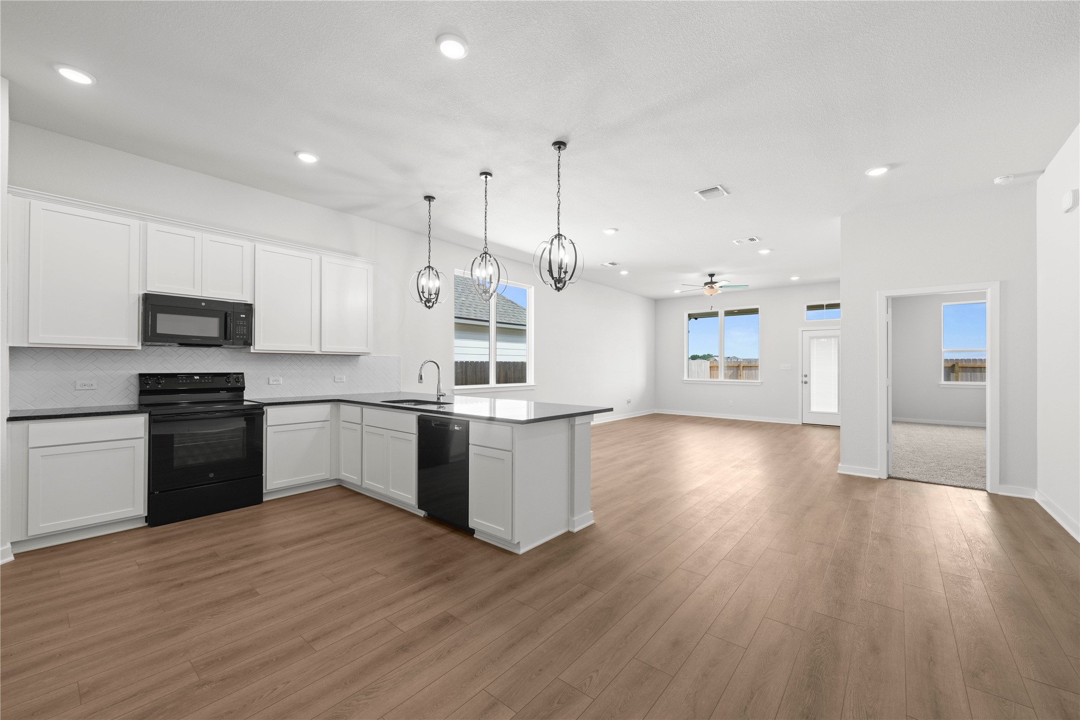 220 Gus Loop Georgetown, TX 78626 - Photo 14 of 18 A well-appointed kitchen featuring a functional island, integrated appliances, and recessed lighting.