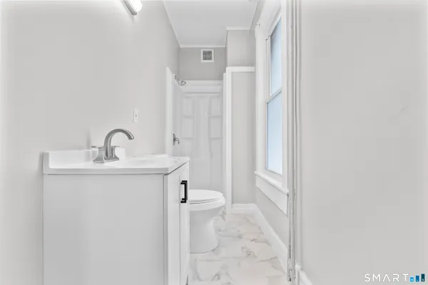 a bathroom with a sink a toilet and a mirror