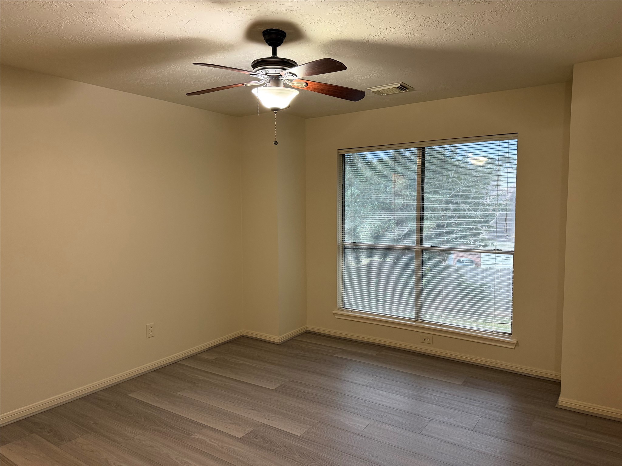 4738 Stoney Point Court Sugar Land, TX 77479 - Photo 13 of 20 a view of an empty room with wooden floor and a window