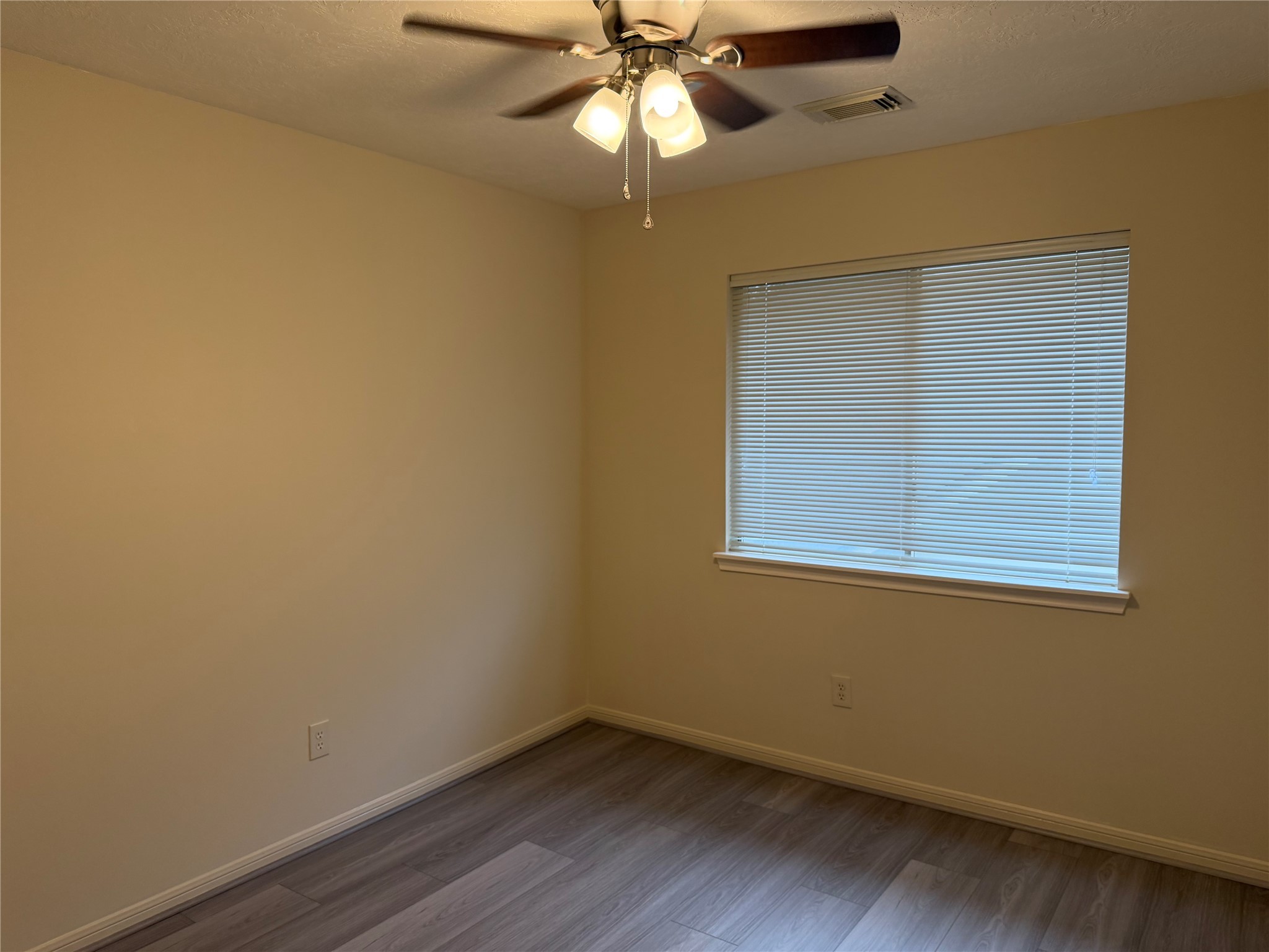 4738 Stoney Point Court Sugar Land, TX 77479 - Photo 16 of 20 an empty room with a window and wooden floor