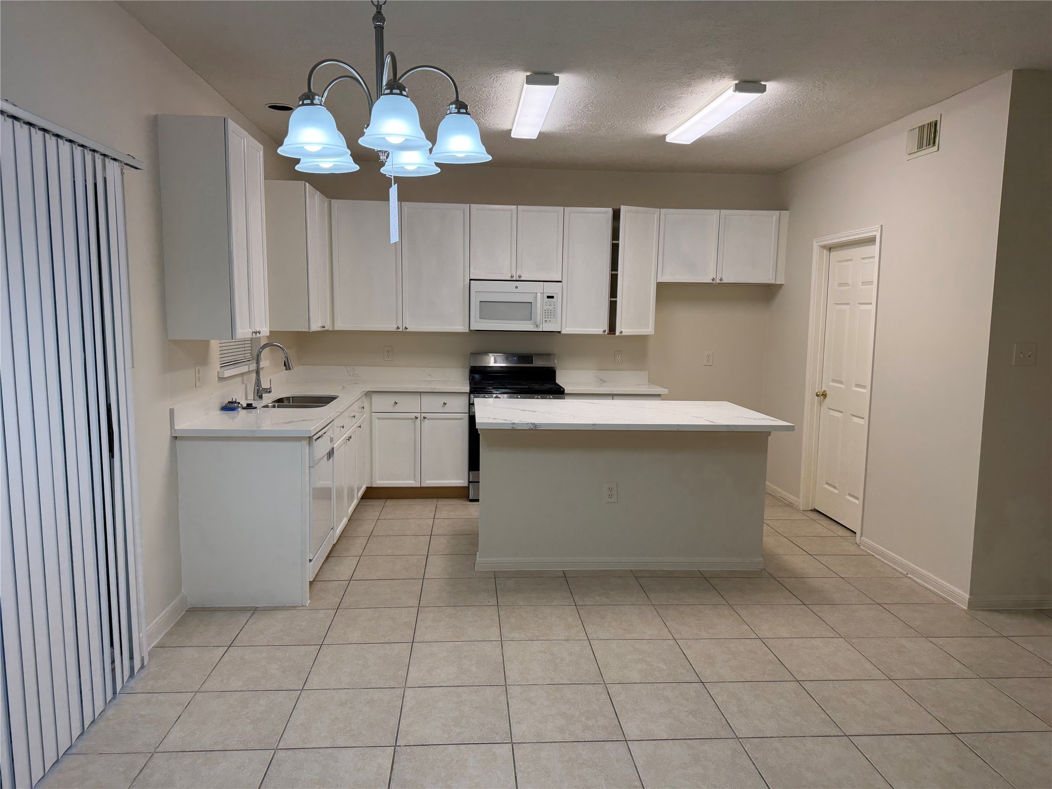 4738 Stoney Point Court Sugar Land, TX 77479 - Photo 5 of 20 a kitchen with a sink window and cabinets