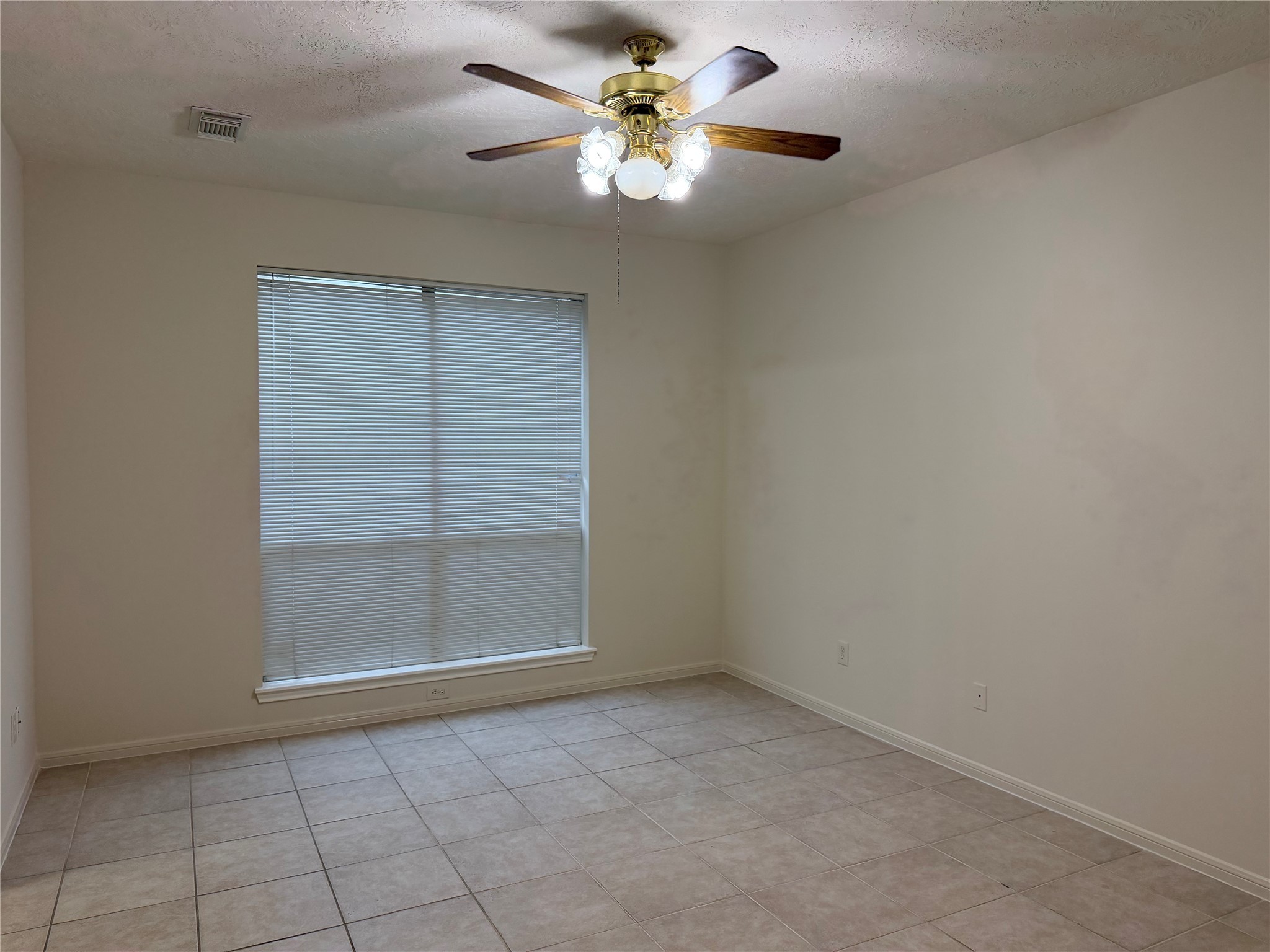 4738 Stoney Point Court Sugar Land, TX 77479 - Photo 9 of 20 an empty room with a chandelier fan and windows