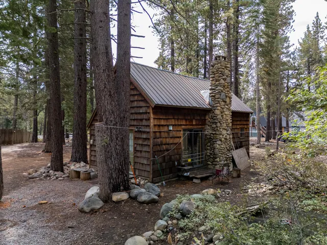 a view of a house with a yard and sitting area