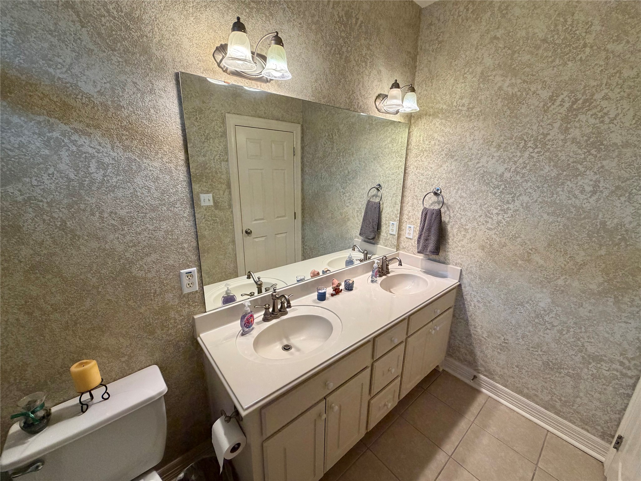 1448 South Blue Bonnet Lane Angleton, TX 77515 - Photo 19 of 43 a bathroom with a sink and a mirror