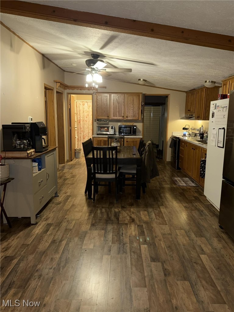 56 3rd Street Rayland, OH 43943 - Photo 38 of 46 Dining area with dark wood-style flooring, a textured ceiling, and a ceiling fan
