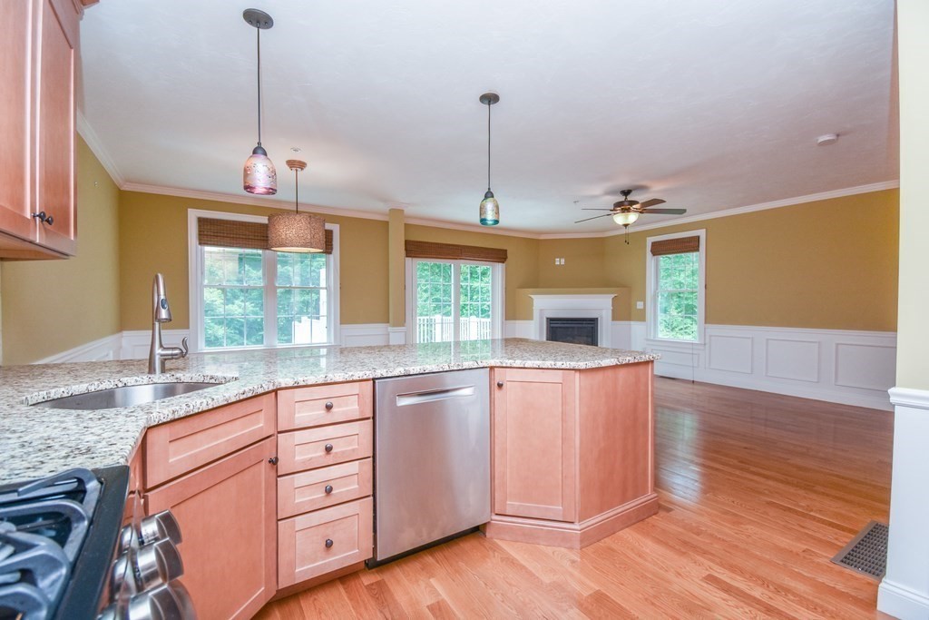 77 Dudley Road, Unit 77 Berlin, MA 01503 - Photo 5 of 30 a kitchen with granite countertop wooden floors and wide window