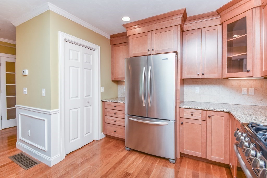 77 Dudley Road, Unit 77 Berlin, MA 01503 - Photo 6 of 30 a kitchen with stainless steel appliances granite countertop a refrigerator and a stove top oven