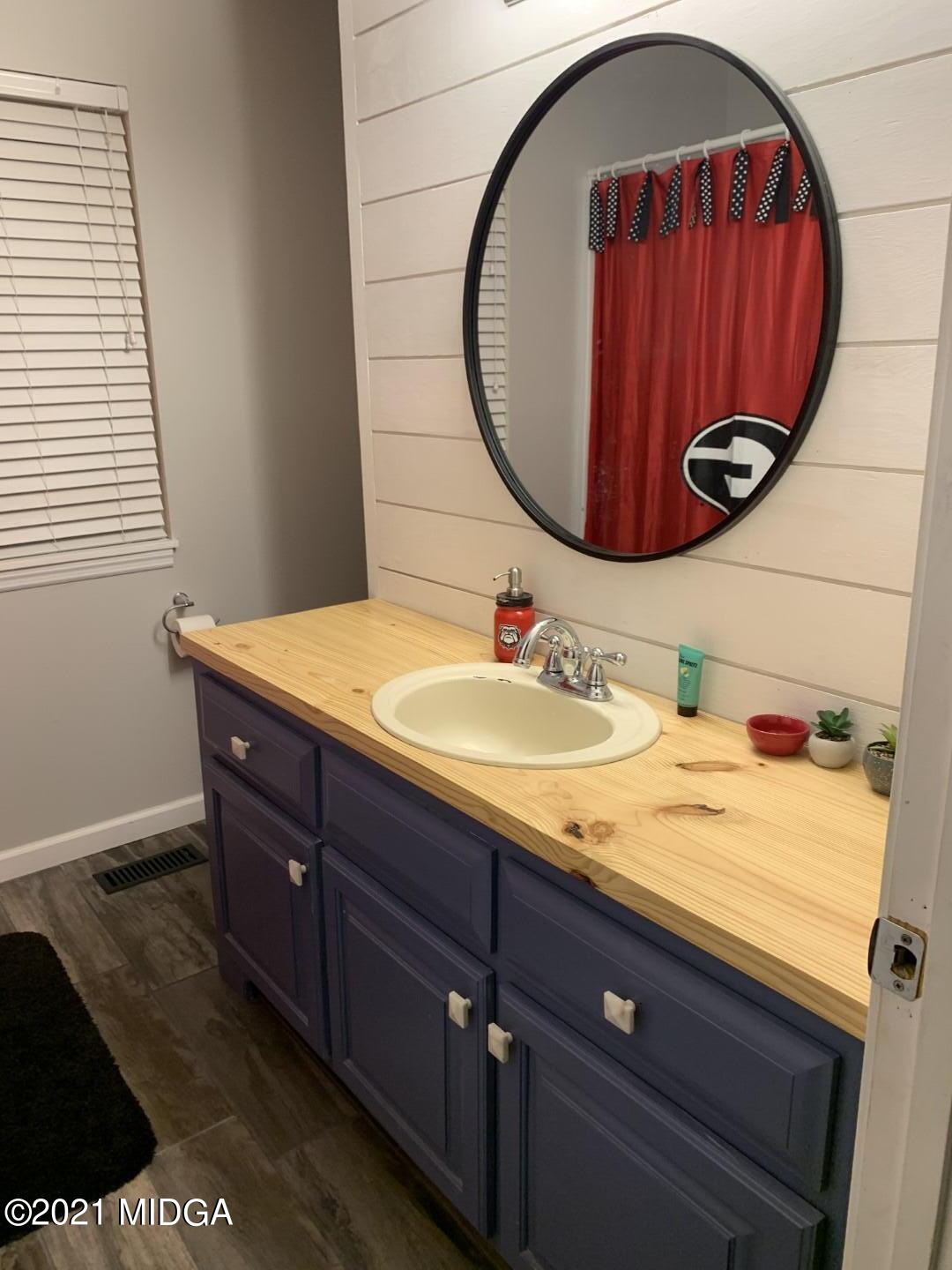 1365 Bass Road Macon, GA 31210 - Photo 14 of 15 a bathroom with a sink and a mirror