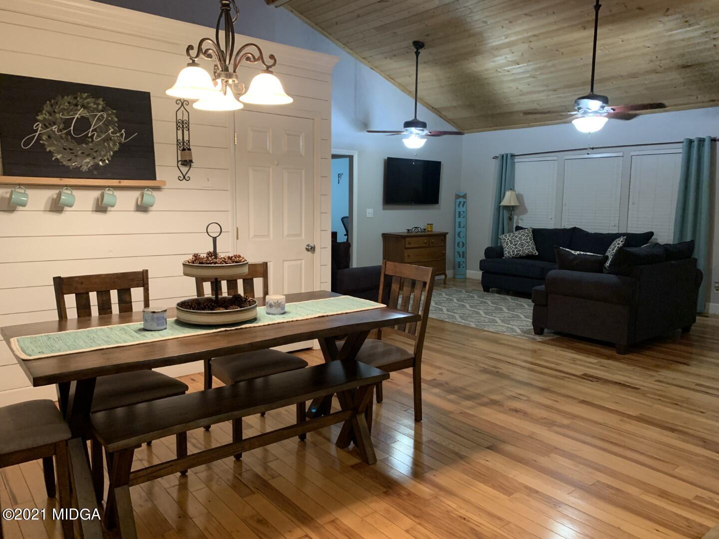 1365 Bass Road Macon, GA 31210 - Photo 3 of 15 a view of a dining room with furniture wooden floor and chandelier