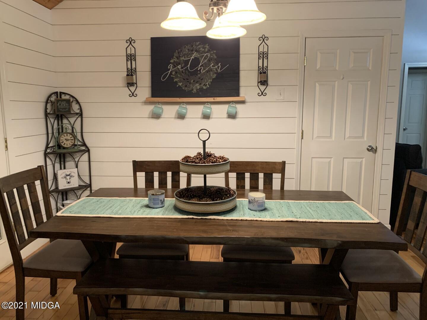 1365 Bass Road Macon, GA 31210 - Photo 5 of 15 a view of a dining room with furniture and wooden floor