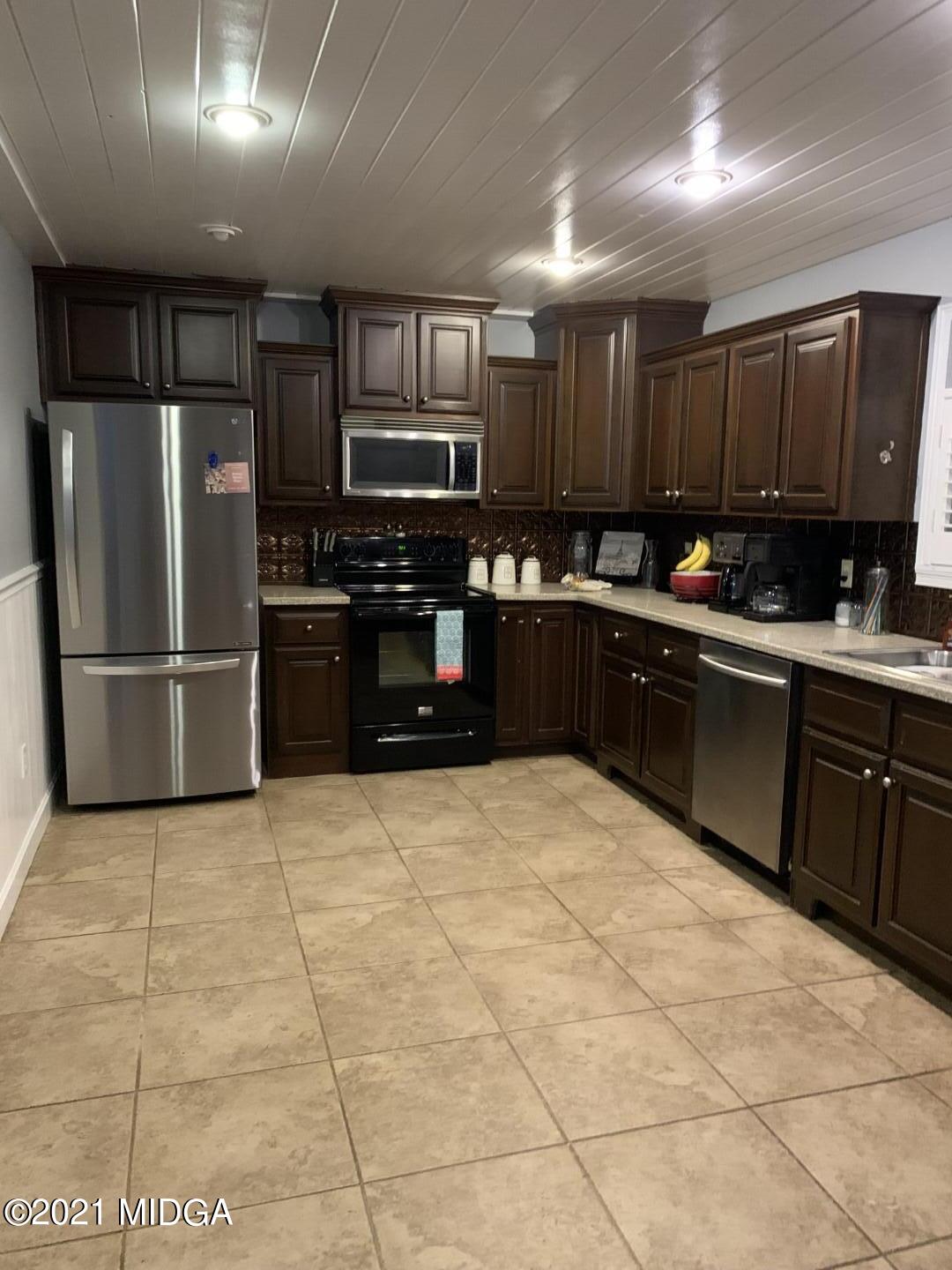 1365 Bass Road Macon, GA 31210 - Photo 6 of 15 a kitchen with stainless steel appliances granite countertop a refrigerator and a stove top oven