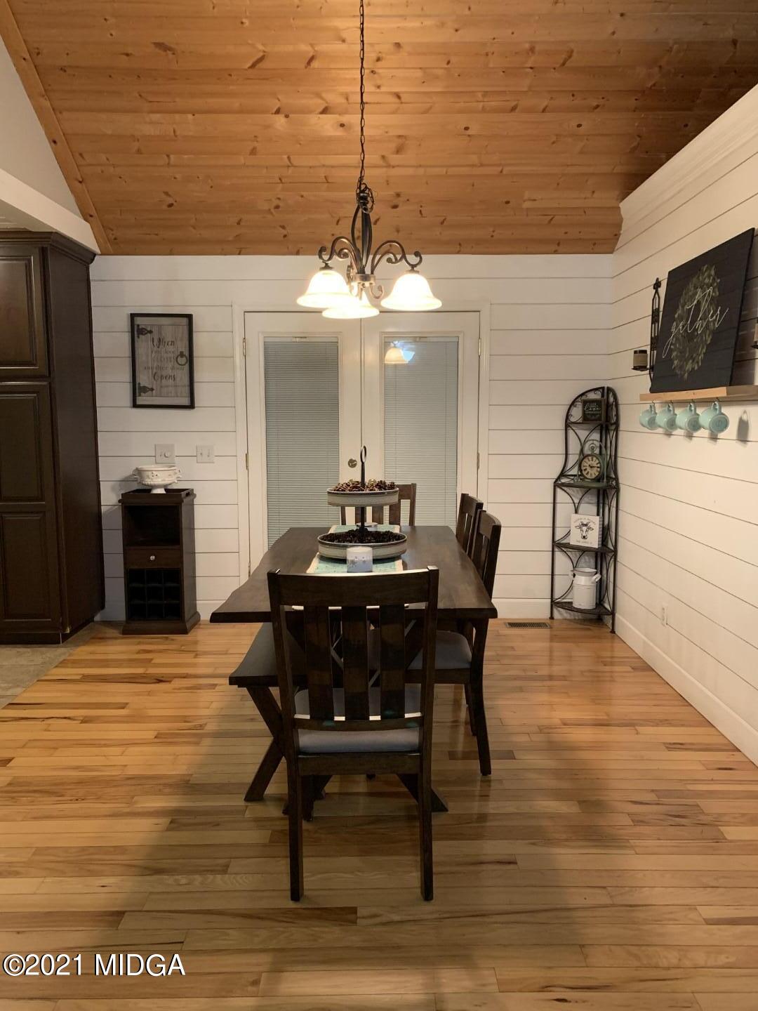 1365 Bass Road Macon, GA 31210 - Photo 7 of 15 a view of a dining room with furniture and a chandelier