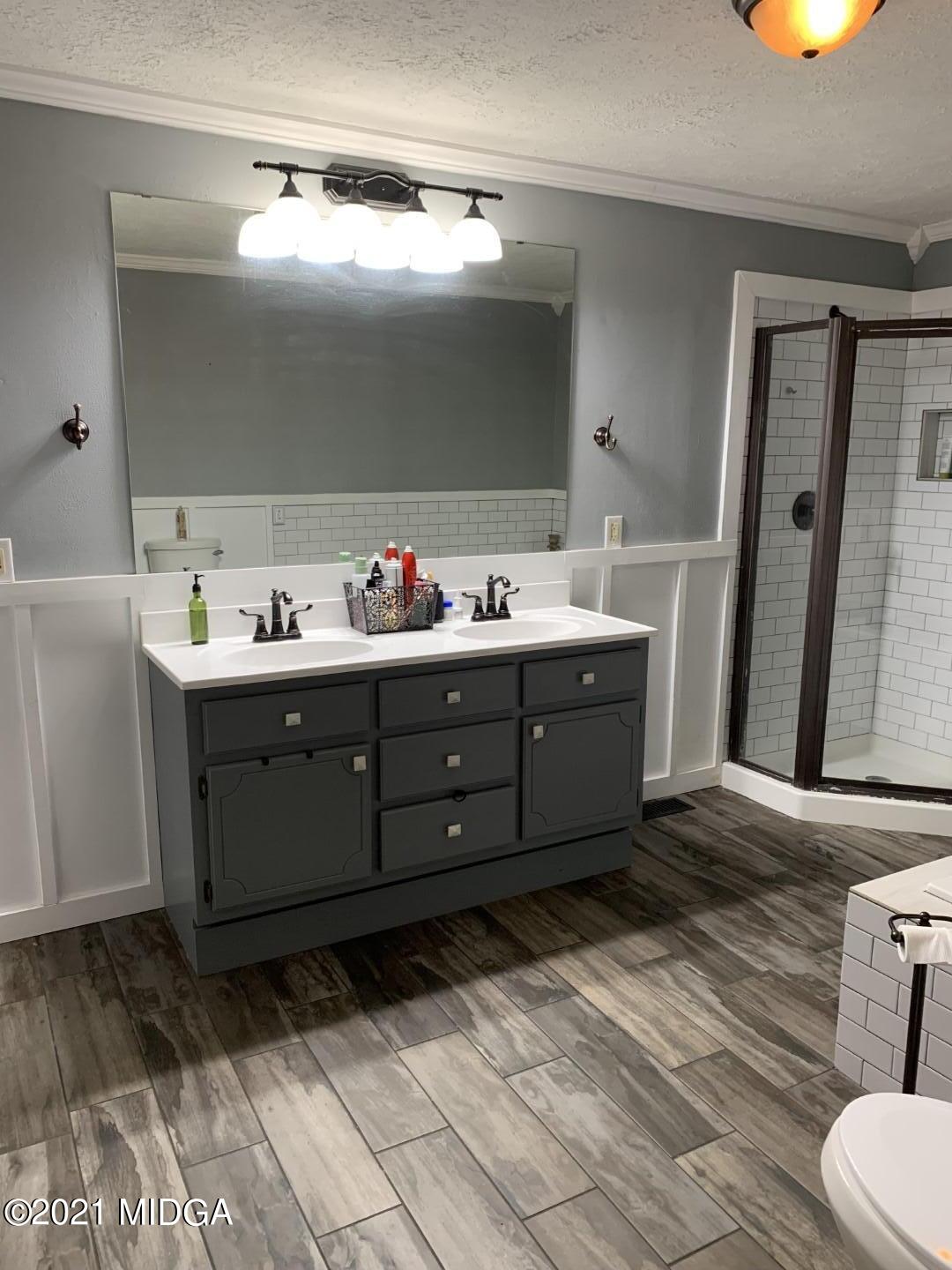 1365 Bass Road Macon, GA 31210 - Photo 9 of 15 a bathroom with a sink and mirror