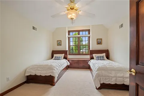 a bedroom with a bed and a chandelier