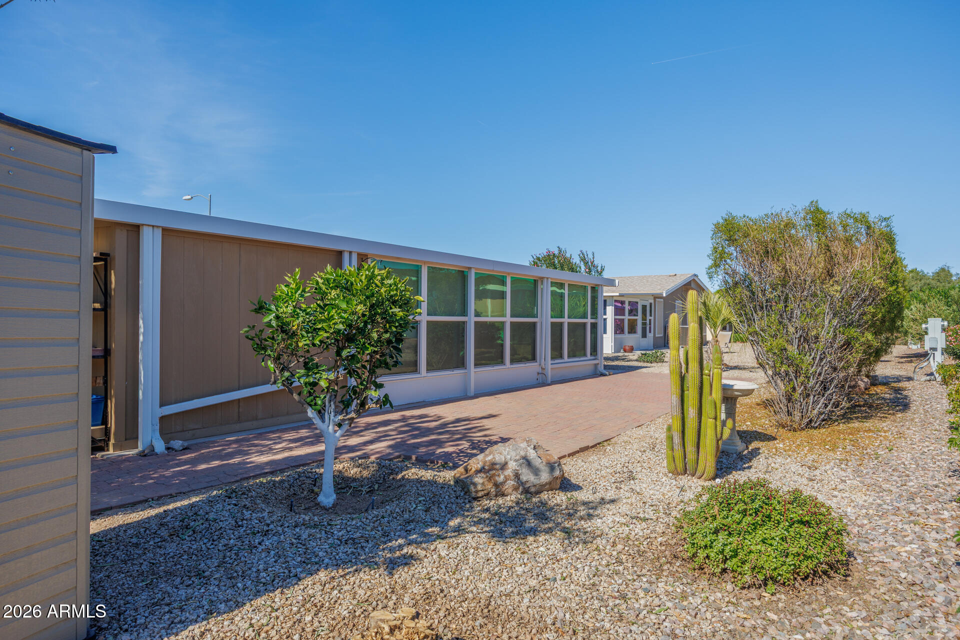 155 East Rodeo Road, Unit 77 Casa Grande, AZ 85122 - Photo 20 of 26 a view of a backyard with plants and large tree