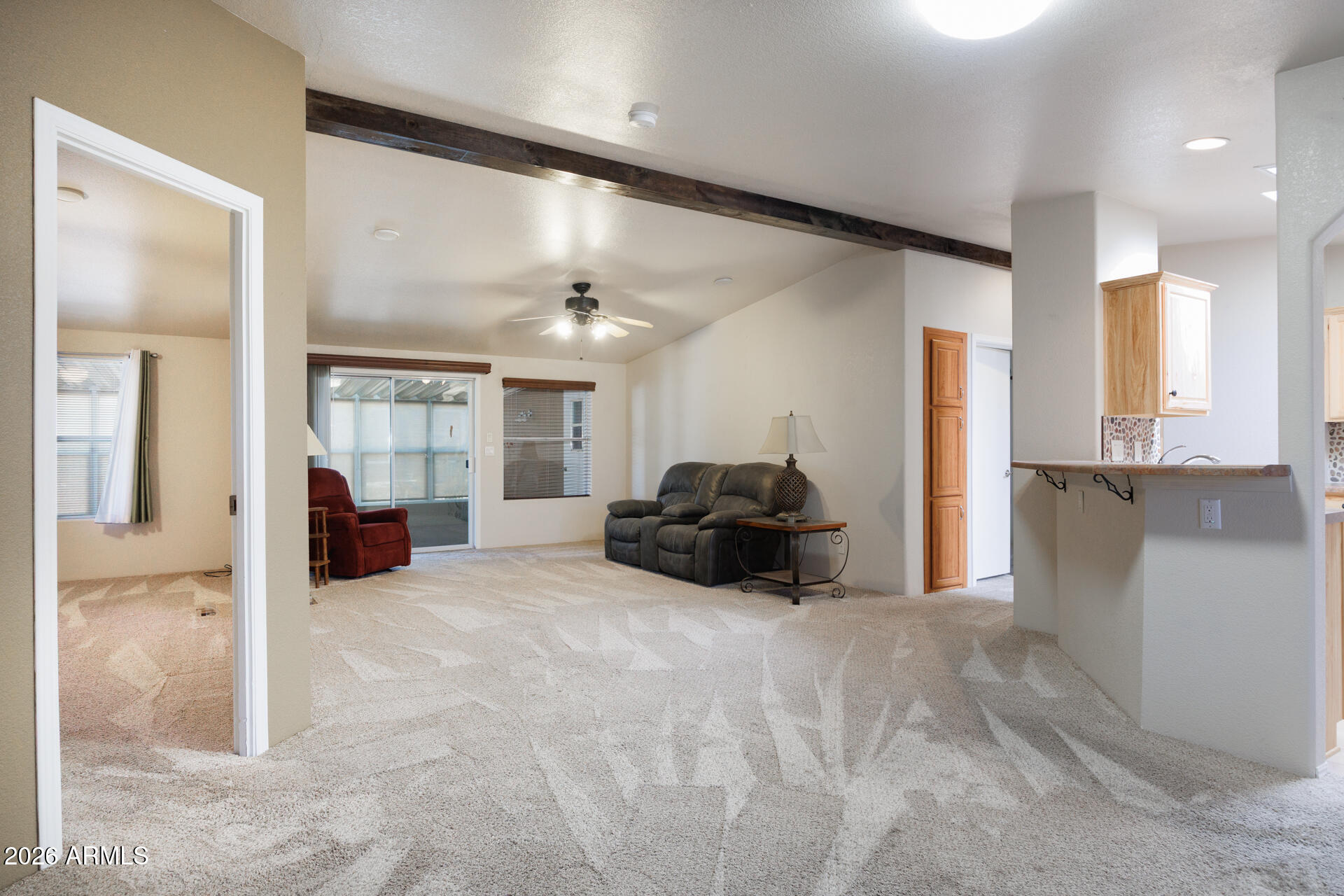 155 East Rodeo Road, Unit 77 Casa Grande, AZ 85122 - Photo 5 of 26 a large bedroom with a bed and a view of kitchen