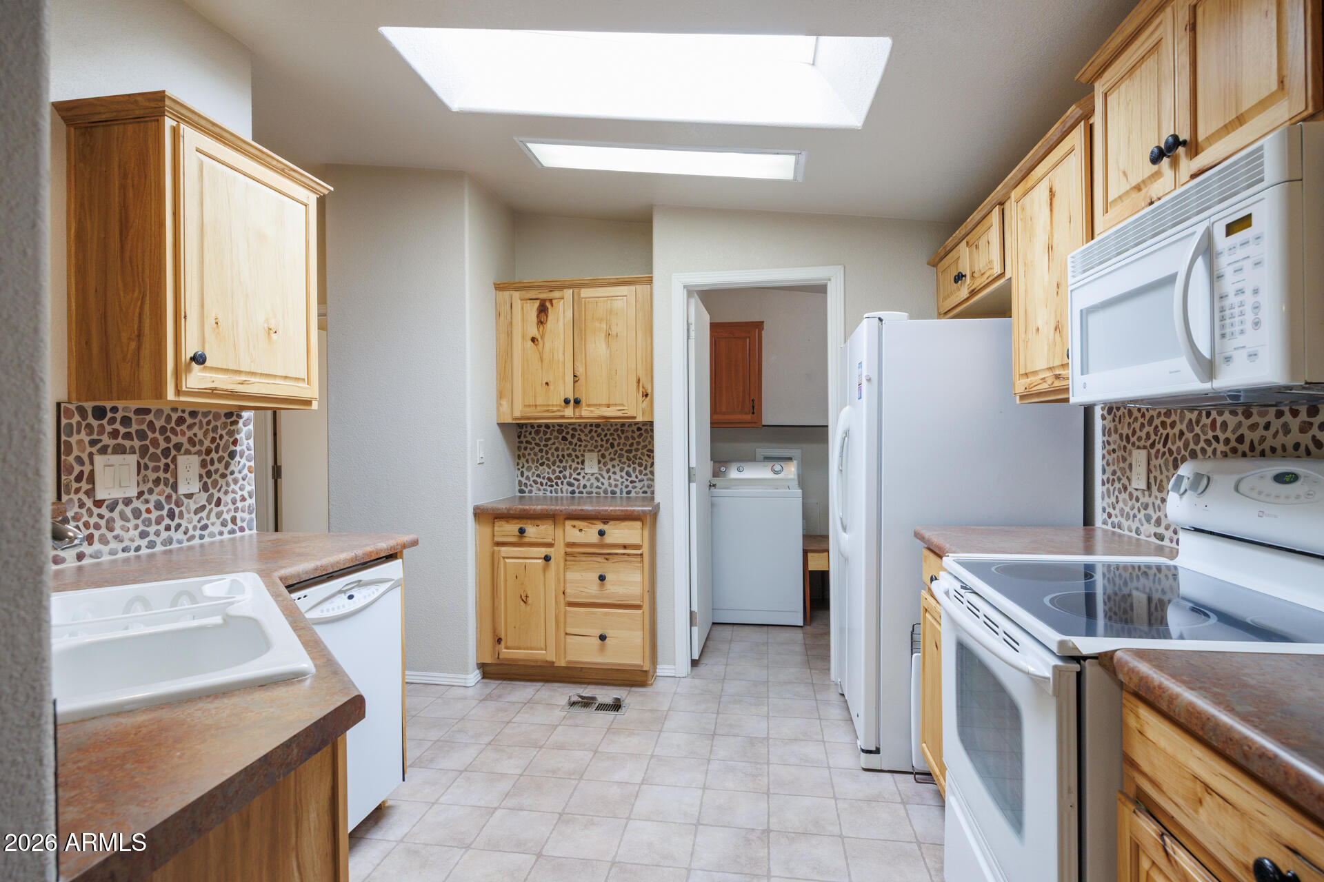 155 East Rodeo Road, Unit 77 Casa Grande, AZ 85122 - Photo 7 of 26 a kitchen with stainless steel appliances granite countertop a refrigerator and a stove