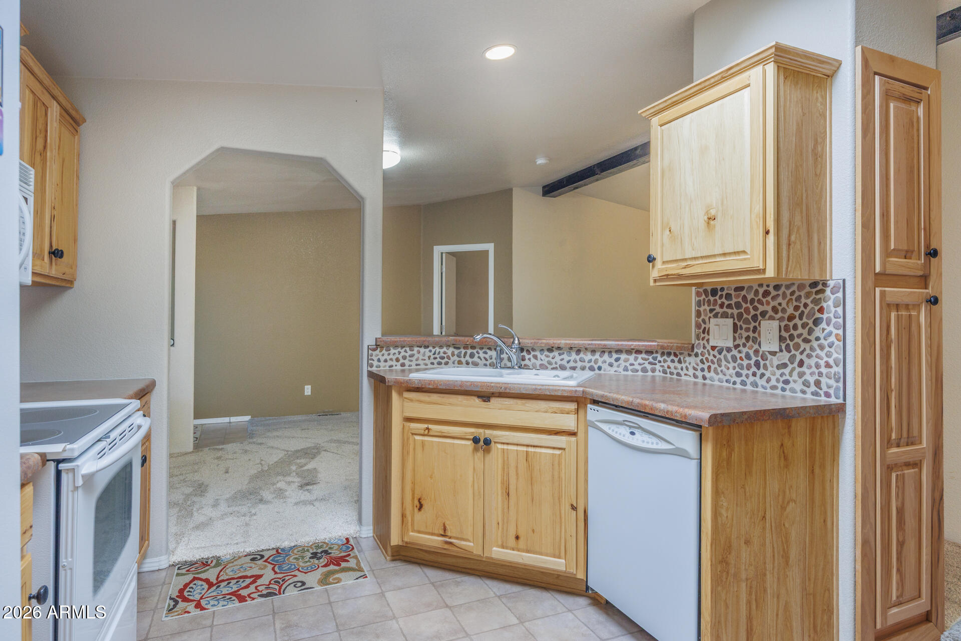 155 East Rodeo Road, Unit 77 Casa Grande, AZ 85122 - Photo 8 of 26 a bathroom with a granite countertop sink a mirror and a vanity