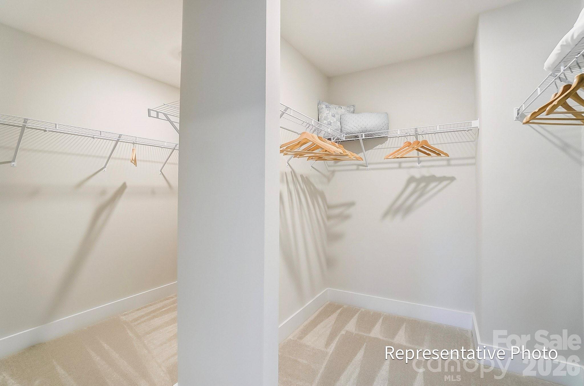 13130 Foxberry Road Charlotte, NC 28213 - Photo 11 of 18 a view of walk in closet with clothes and shoes