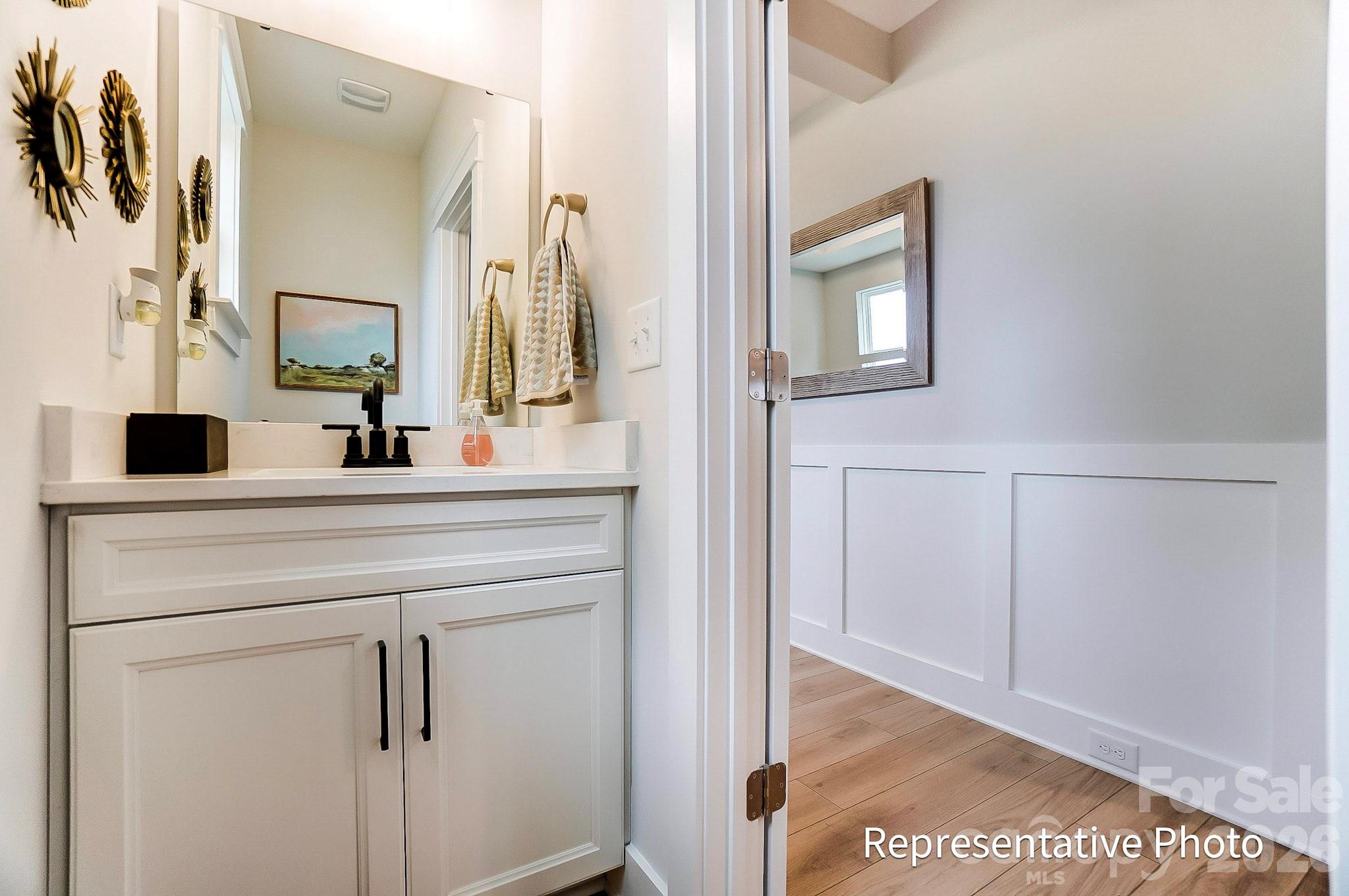 13130 Foxberry Road Charlotte, NC 28213 - Photo 3 of 18 a bathroom with a vanity and a mirror