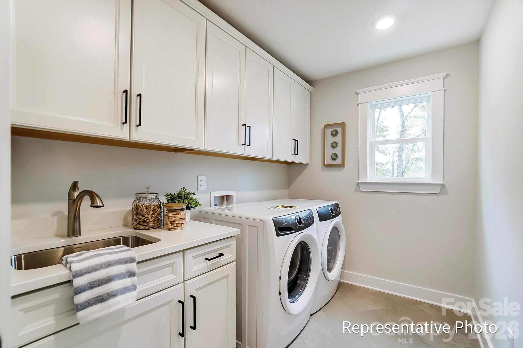 13130 Foxberry Road Charlotte, NC 28213 - Photo 7 of 18 a view of washer and dryer with kitchen countertops