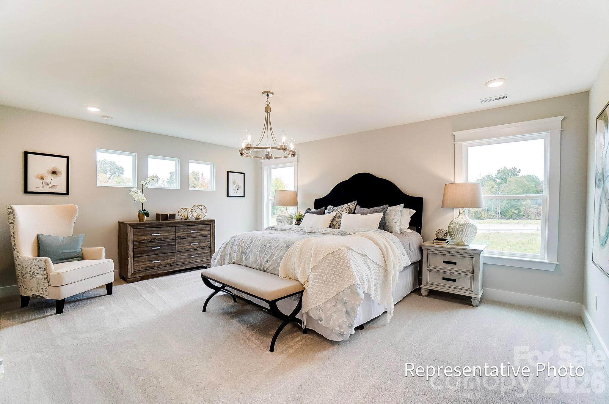 13130 Foxberry Road Charlotte, NC 28213 - Photo 8 of 18 a spacious bedroom with a bed and a couch