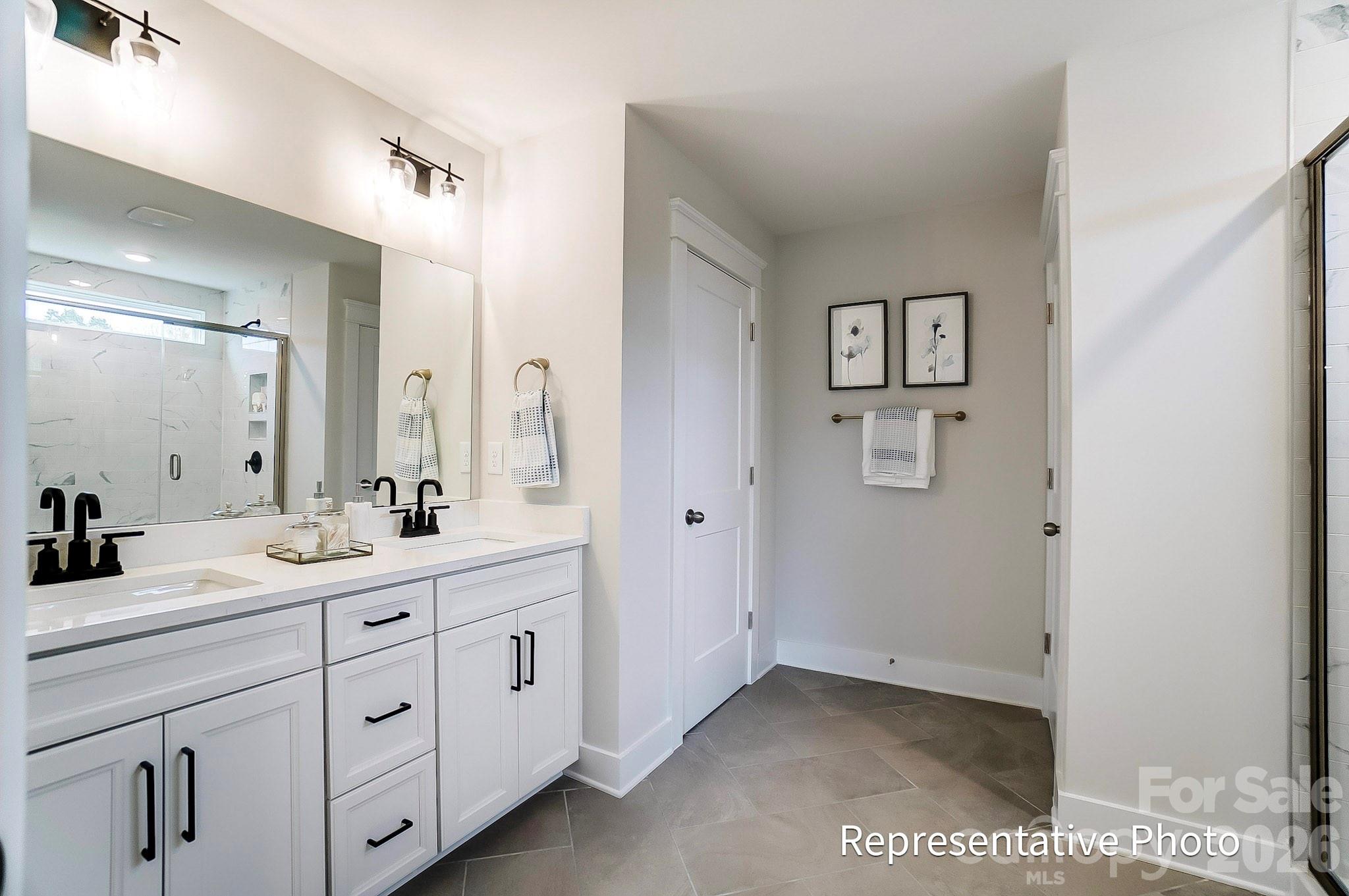 13130 Foxberry Road Charlotte, NC 28213 - Photo 9 of 18 a spacious bathroom with a double vanity sink a mirror a and a