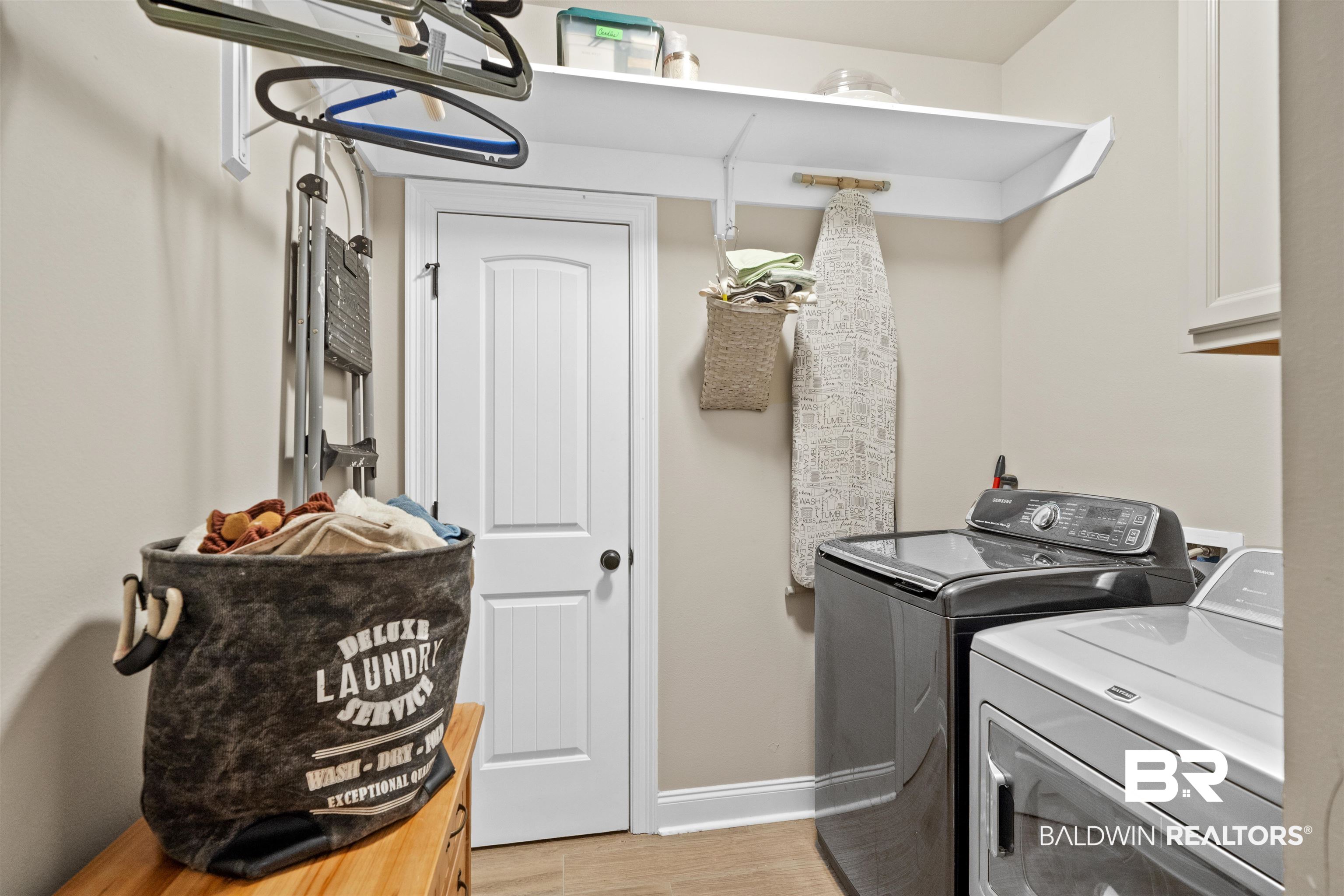 1509 Fenton Circle Foley, AL 36535 - Photo 17 of 34 Laundry room with baseboards, cabinet space, light wood-style floors, and washer and clothes dryer