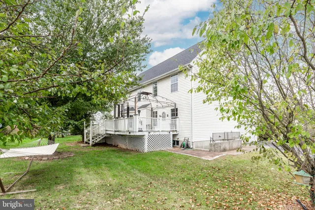 a view of house with backyard and a garden