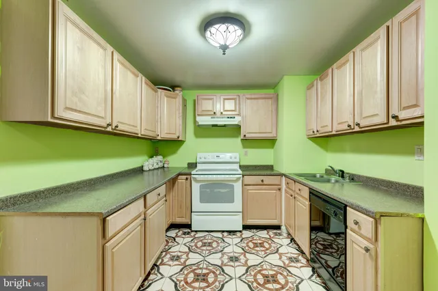 a kitchen with stainless steel appliances granite countertop a sink and cabinets