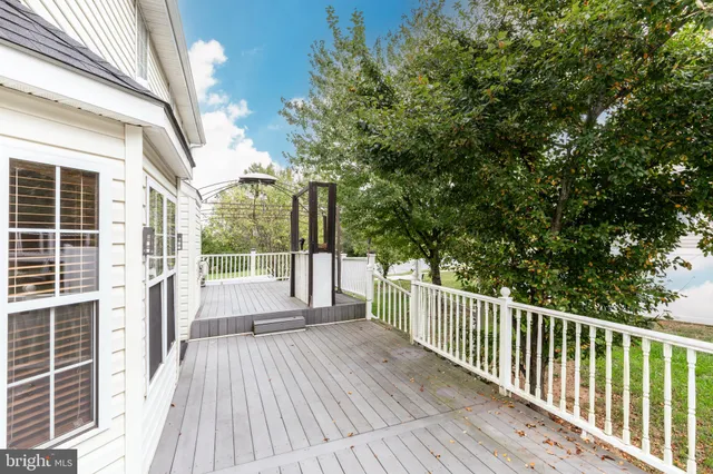 a view of balcony with wooden floor and fence