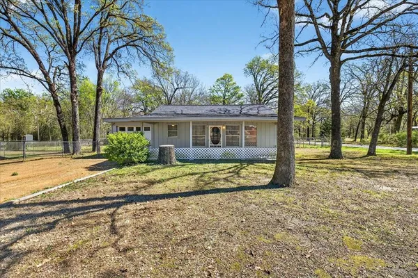 a view of a house with a backyard and a tree