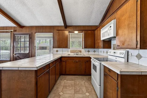 a kitchen with a sink stove and cabinets