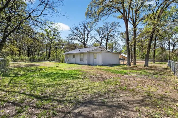 a front view of house with yard and trees