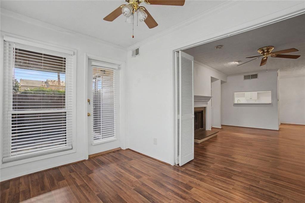 319 Park Ridge Circle Marietta, GA 30068 - Photo 18 of 32 an empty room with wooden floor chandelier fan and windows