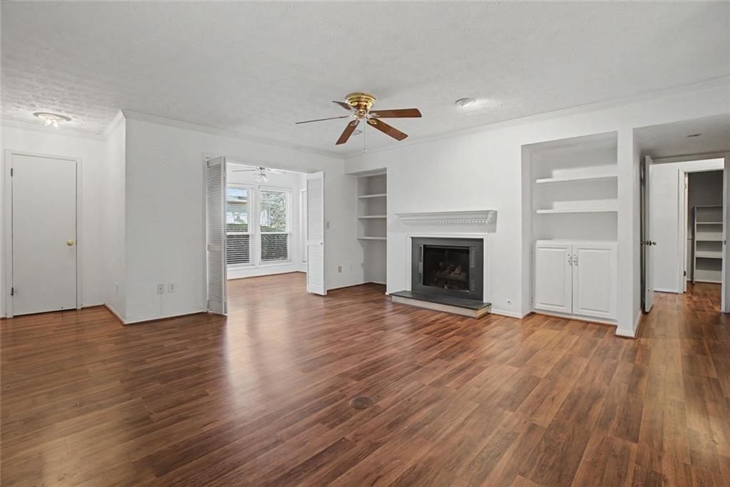 319 Park Ridge Circle Marietta, GA 30068 - Photo 20 of 32 an empty room with wooden floor fireplace and windows
