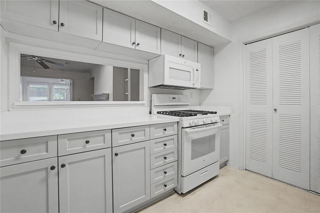 319 Park Ridge Circle Marietta, GA 30068 - Photo 27 of 32 a kitchen with white cabinets and white appliances