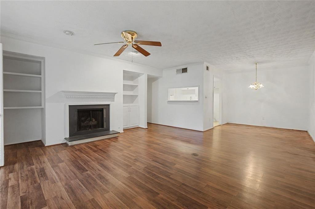 319 Park Ridge Circle Marietta, GA 30068 - Photo 8 of 32 a view of empty room with wooden floor and fireplace
